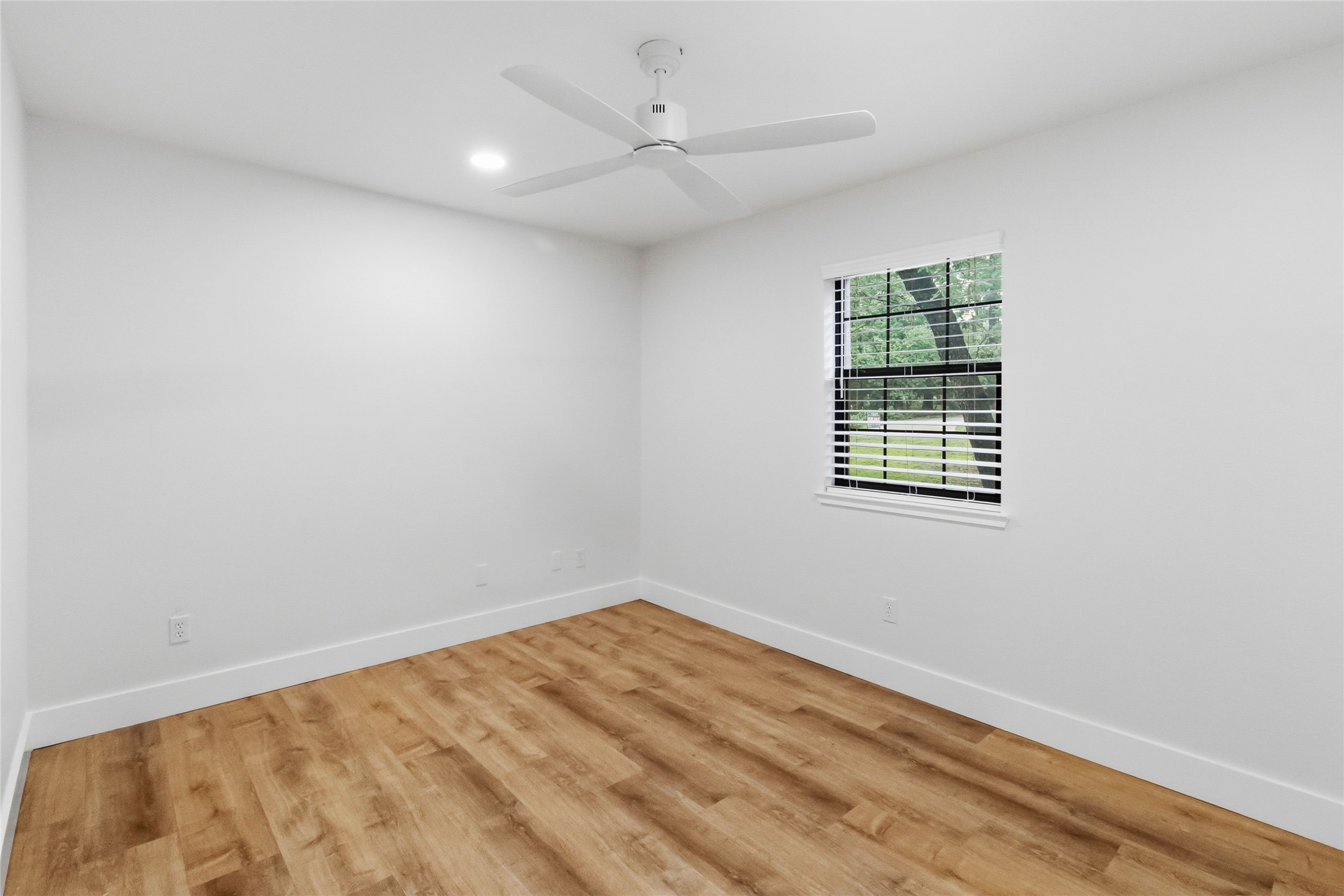 326 Pine View Loop Bastrop, TX 78602 - Photo 17 of 30 A well-lit bedroom features durable laminate flooring and a ceiling fan for comfort.
