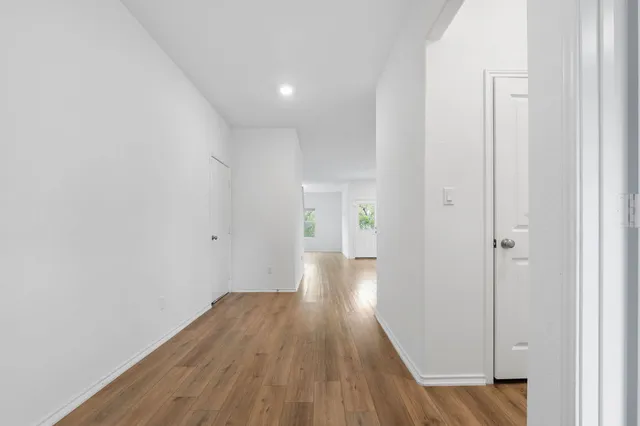 a view of a hallway with wooden floor