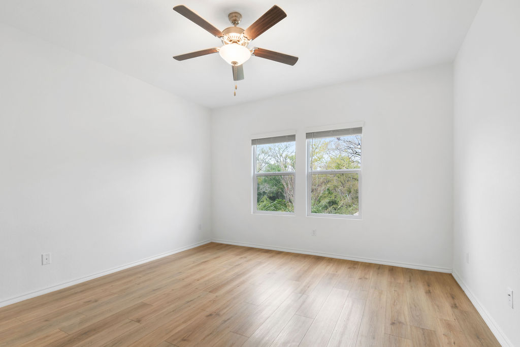 1205 Sweetspire Street Leander, TX 78641 - Photo 17 of 31 Unfurnished room featuring light wood-style floors and a ceiling fan