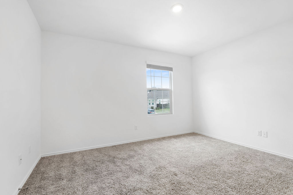1205 Sweetspire Street Leander, TX 78641 - Photo 24 of 31 Carpeted empty room featuring baseboards