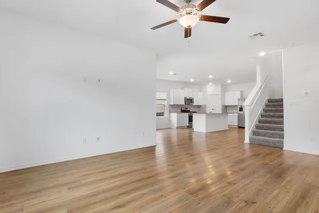 a view of kitchen and hall with wooden floor