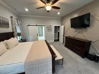 a bedroom with a bed and a flat screen tv