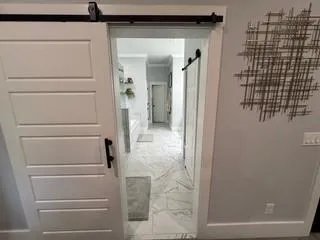 a bathroom with a shower and closet