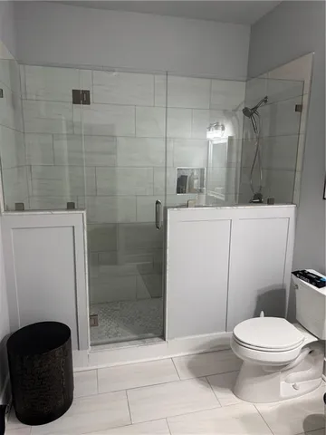 a bathroom with a toilet and a shower