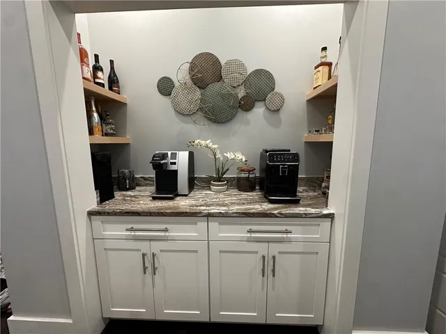 a kitchen with white cabinets and a sink