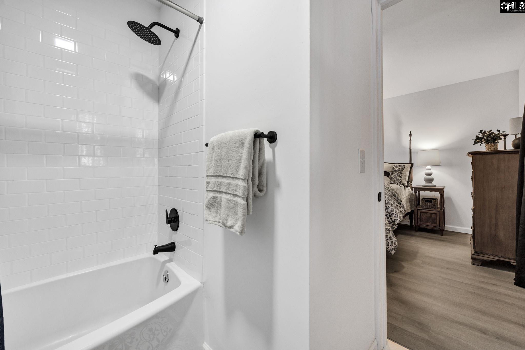 8107 Black River Road Rembert, SC 29128 - Photo 21 of 38 a bathroom with a tub a mirror and a shower
