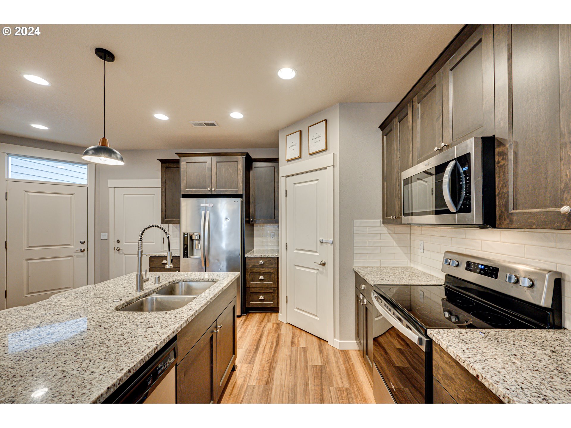 7252 South 13th Street Ridgefield, WA 98642 - Photo 6 of 29 a kitchen with stainless steel appliances granite countertop a sink a stove and a refrigerator