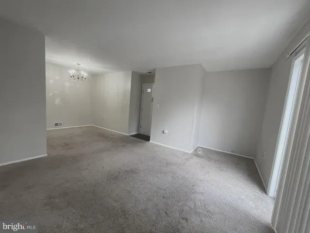 a kitchen with stainless steel appliances white cabinets and a refrigerator