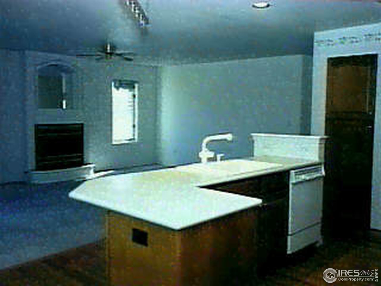 7641 Monarch Road Niwot, CO 80503 - Photo 2 of 8 a kitchen with a sink a table and chairs
