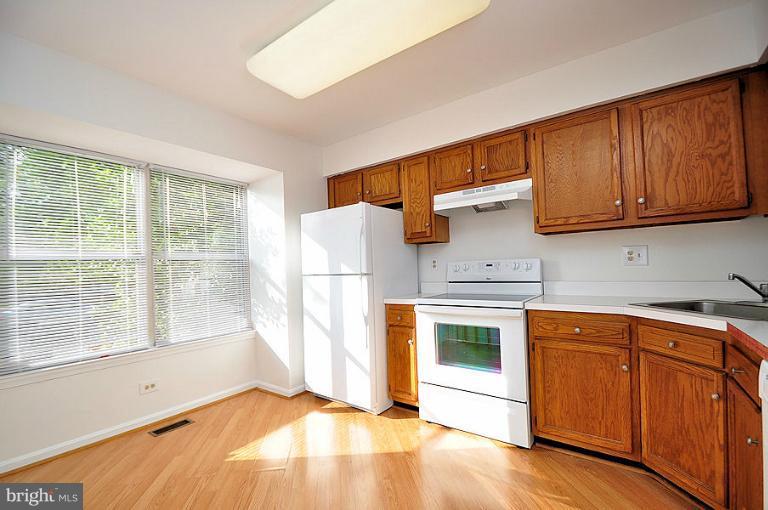 9537 Clocktower Lane Columbia, MD 21046 - Photo 2 of 16 a view of a kitchen with a sink dishwasher and a fireplace