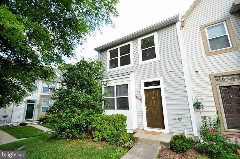 9537 Clocktower Lane Columbia, MD 21046 - Photo 16 of 16 a front view of a house with a yard