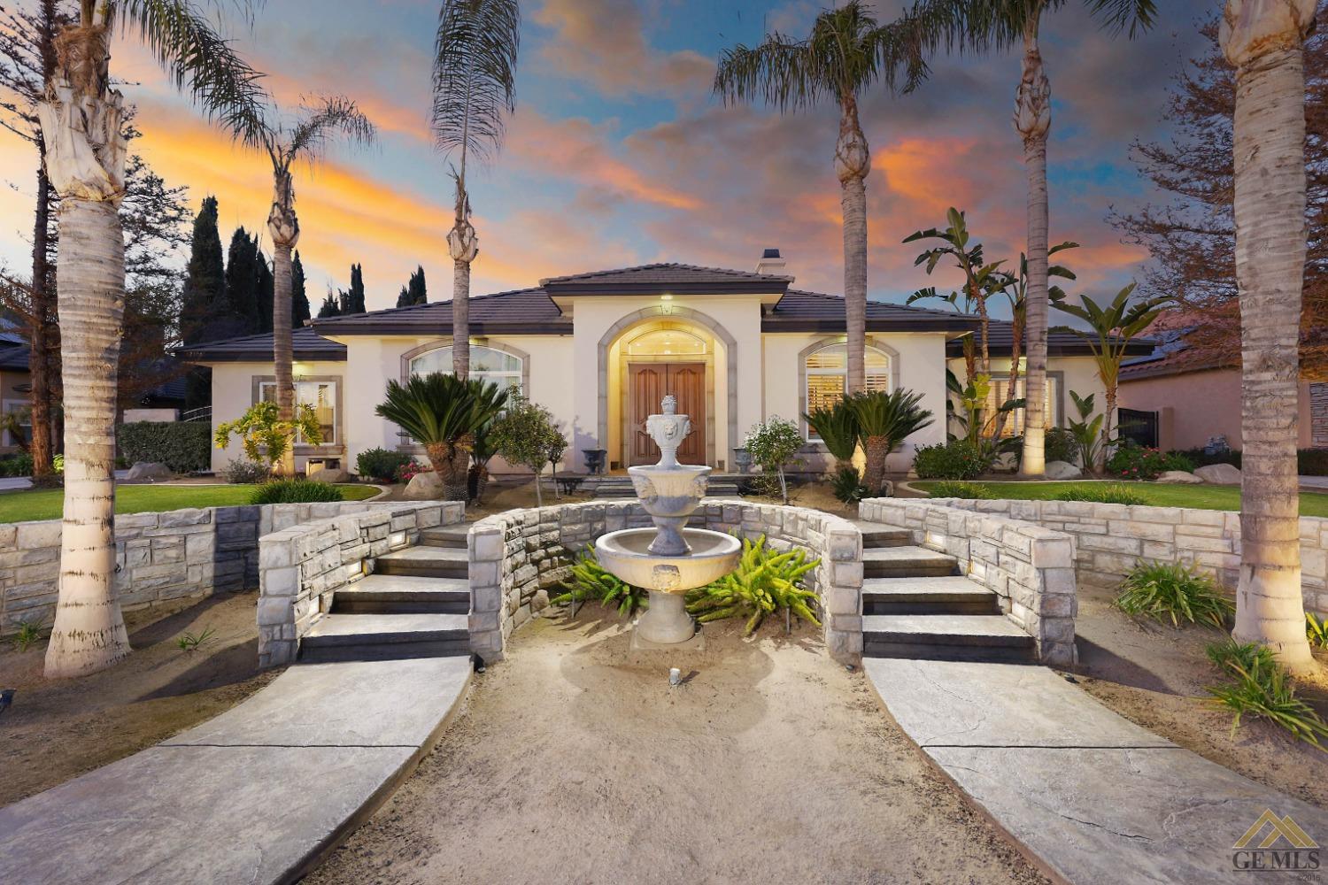 Undisclosed Address Bakersfield, CA 93312 - Photo 1 of 48 a view of a patio with couches table and chairs with potted plants and palm trees