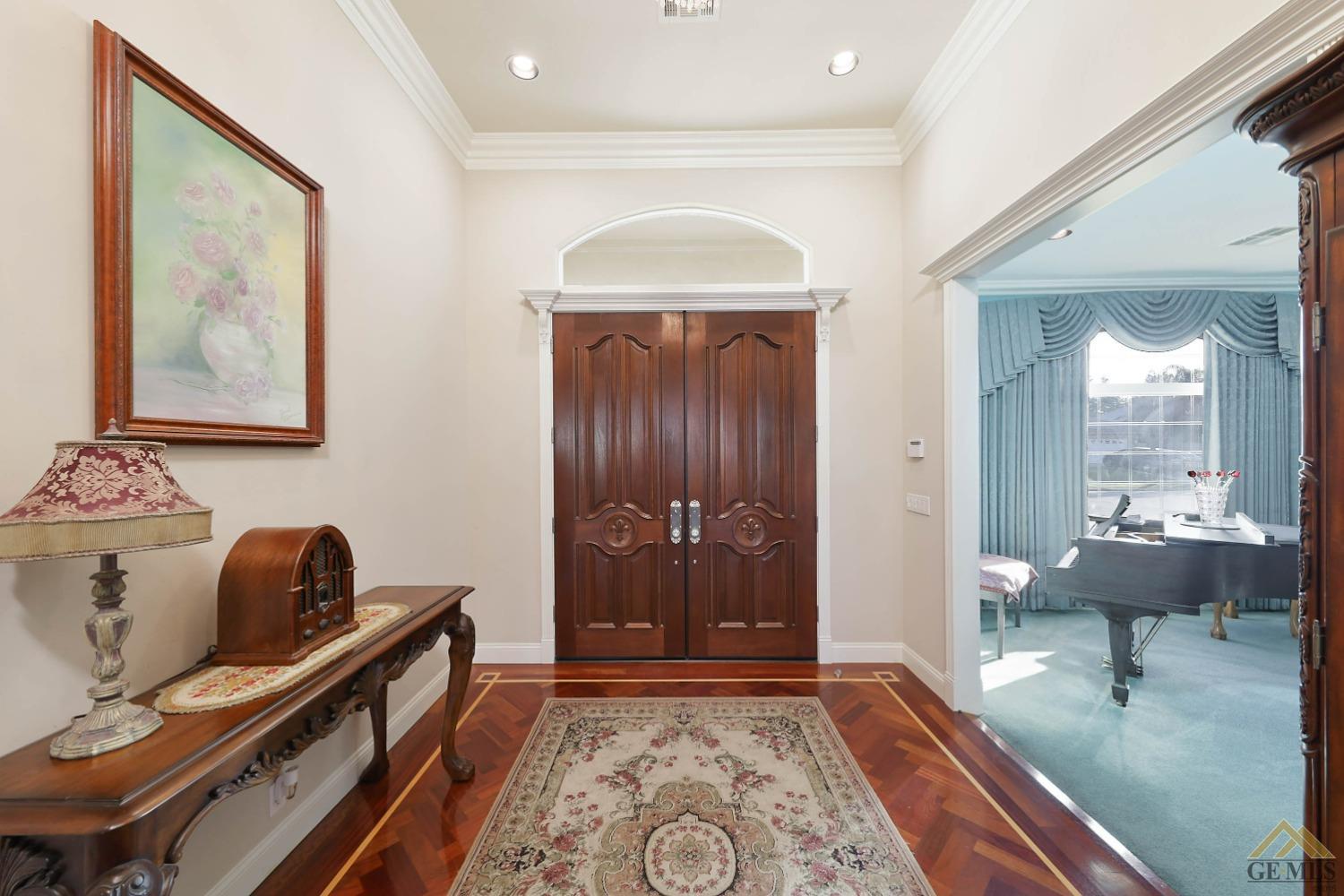 Undisclosed Address Bakersfield, CA 93312 - Photo 11 of 48 a hallway with a couch and chandelier