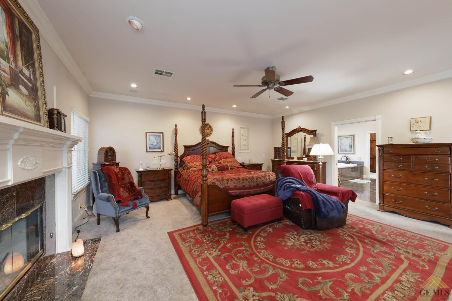 Undisclosed Address Bakersfield, CA 93312 - Photo 13 of 48 a living room with furniture a fireplace and a ceiling fan