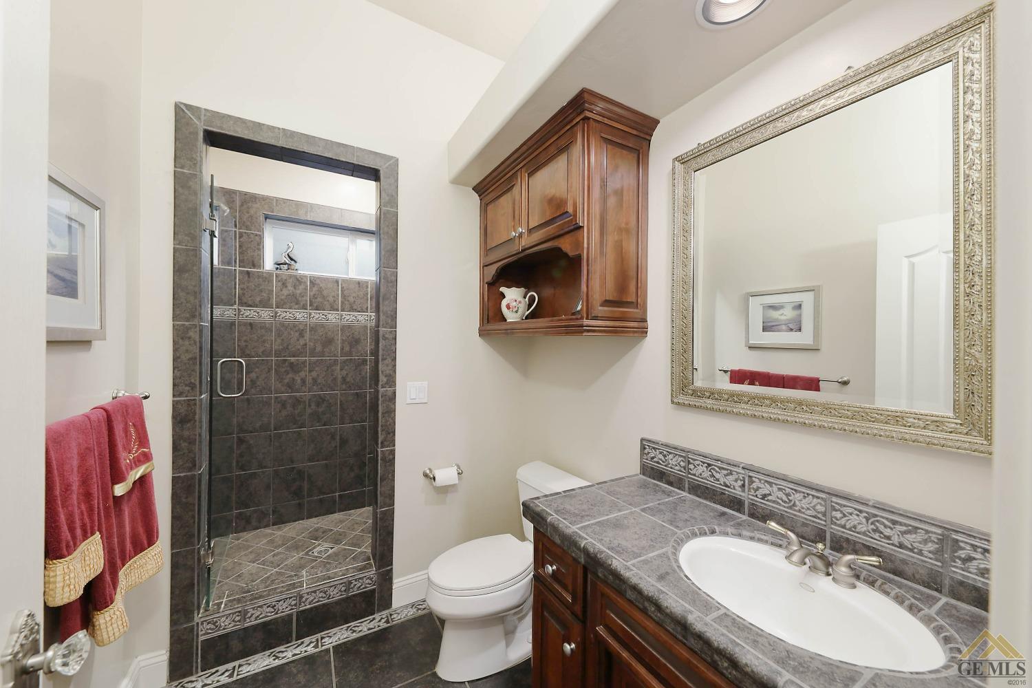 Undisclosed Address Bakersfield, CA 93312 - Photo 24 of 48 a bathroom with a sink toilet and shower