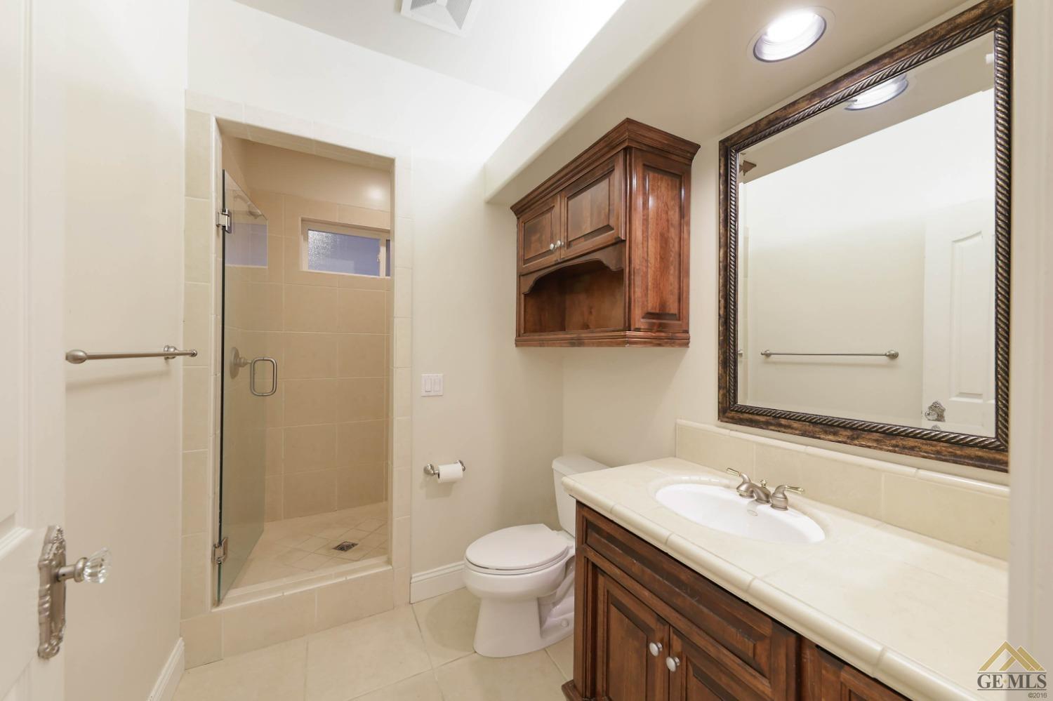 Undisclosed Address Bakersfield, CA 93312 - Photo 33 of 48 a bathroom with a sink a toilet and shower