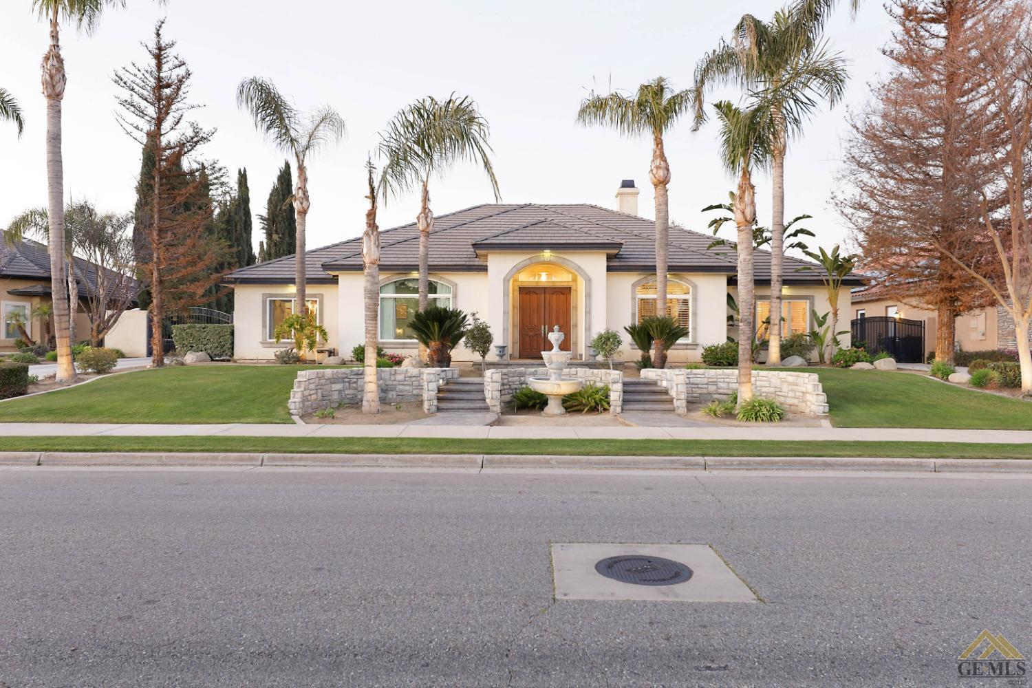 Undisclosed Address Bakersfield, CA 93312 - Photo 44 of 48 a view of a house with a yard and palm trees