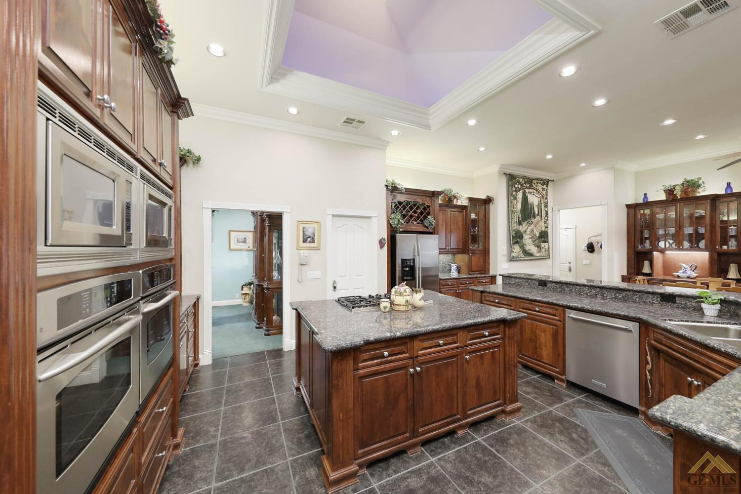 Undisclosed Address Bakersfield, CA 93312 - Photo 5 of 48 a kitchen with stainless steel appliances granite countertop a sink stove and cabinets