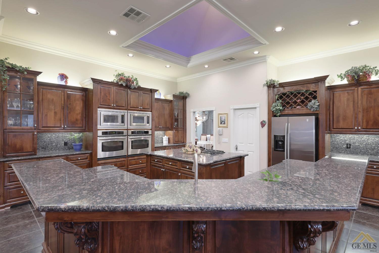 Undisclosed Address Bakersfield, CA 93312 - Photo 6 of 48 a large kitchen with kitchen island a counter top space a sink stainless steel appliances and cabinets