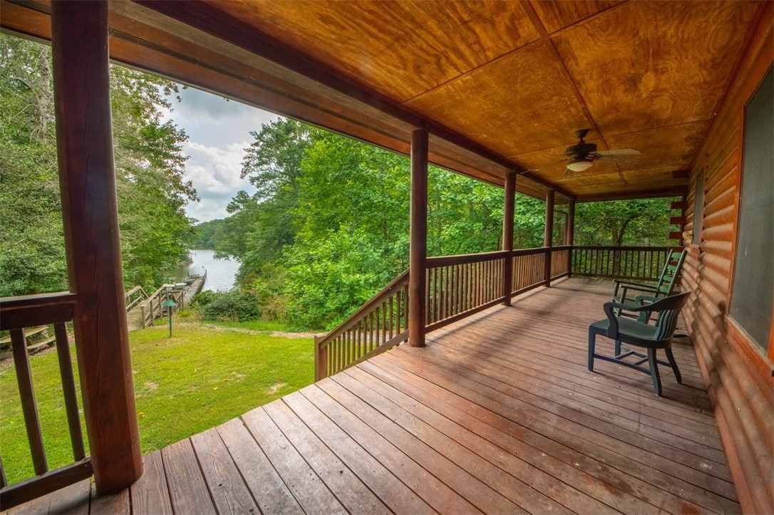 846 Twiggs Ferry Road Hartfield, VA 23071 - Photo 22 of 28 Deck with a ceiling fan, a lawn, and a water view