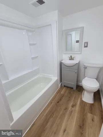 a white bath tub sitting next to a white toilet
