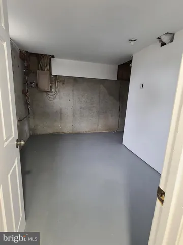a view of storage and utility room with a refrigerator