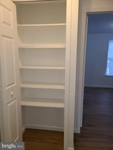 a view of walk in closet with empty racks