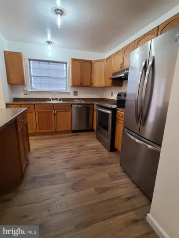 a kitchen with stainless steel appliances and a refrigerator