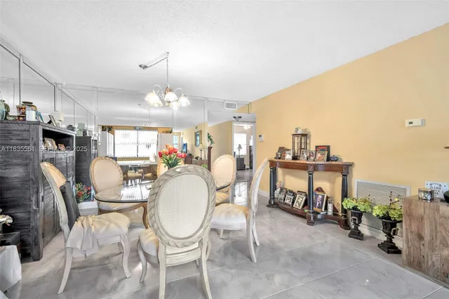 a living room with furniture a fireplace and a chandelier