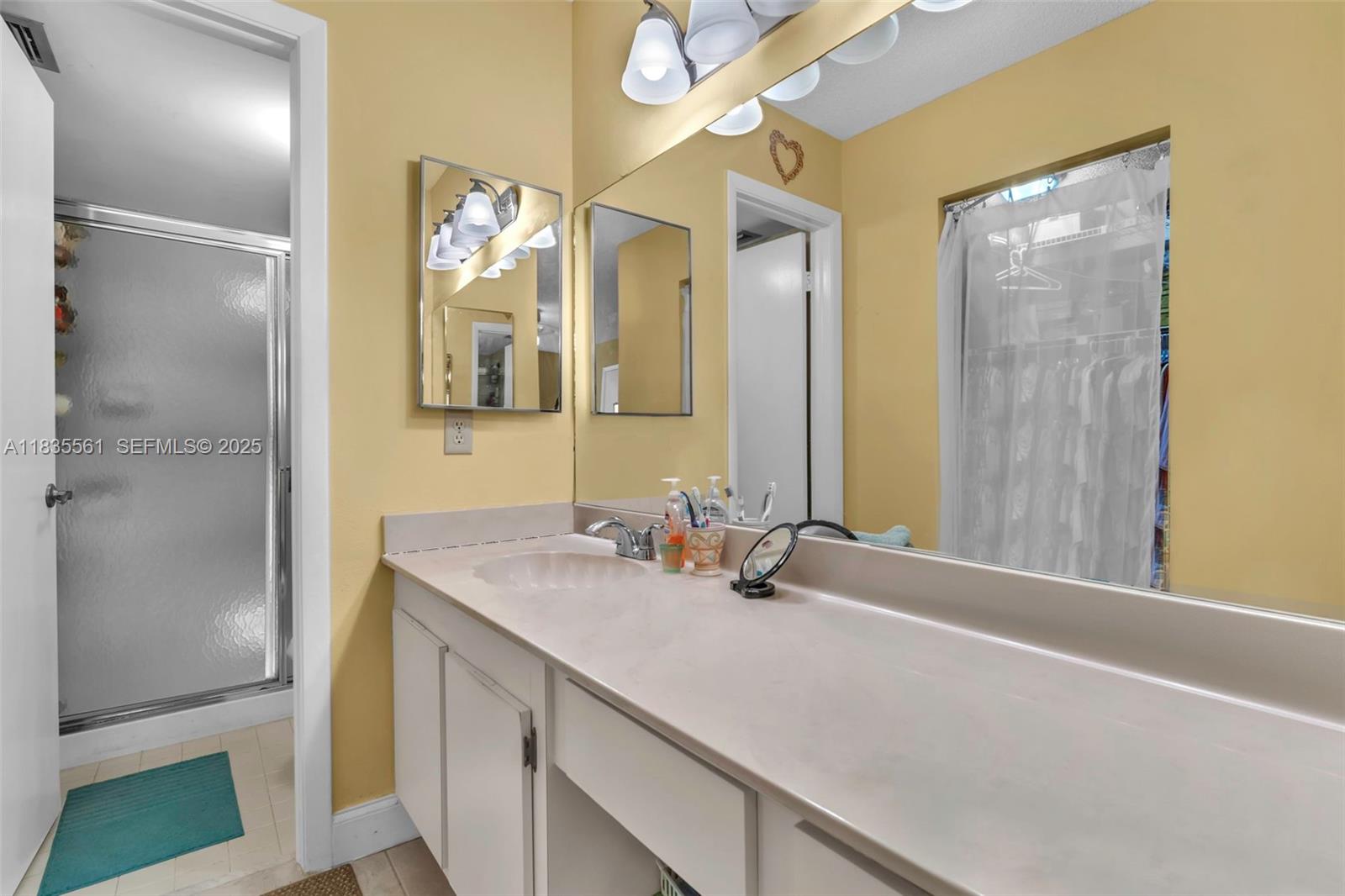10400 Northwest 30th Court, Unit 305 Sunrise, FL 33322 - Photo 19 of 26 a bathroom with a sink and a mirror