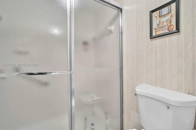 a bathroom with a shower and a toilet