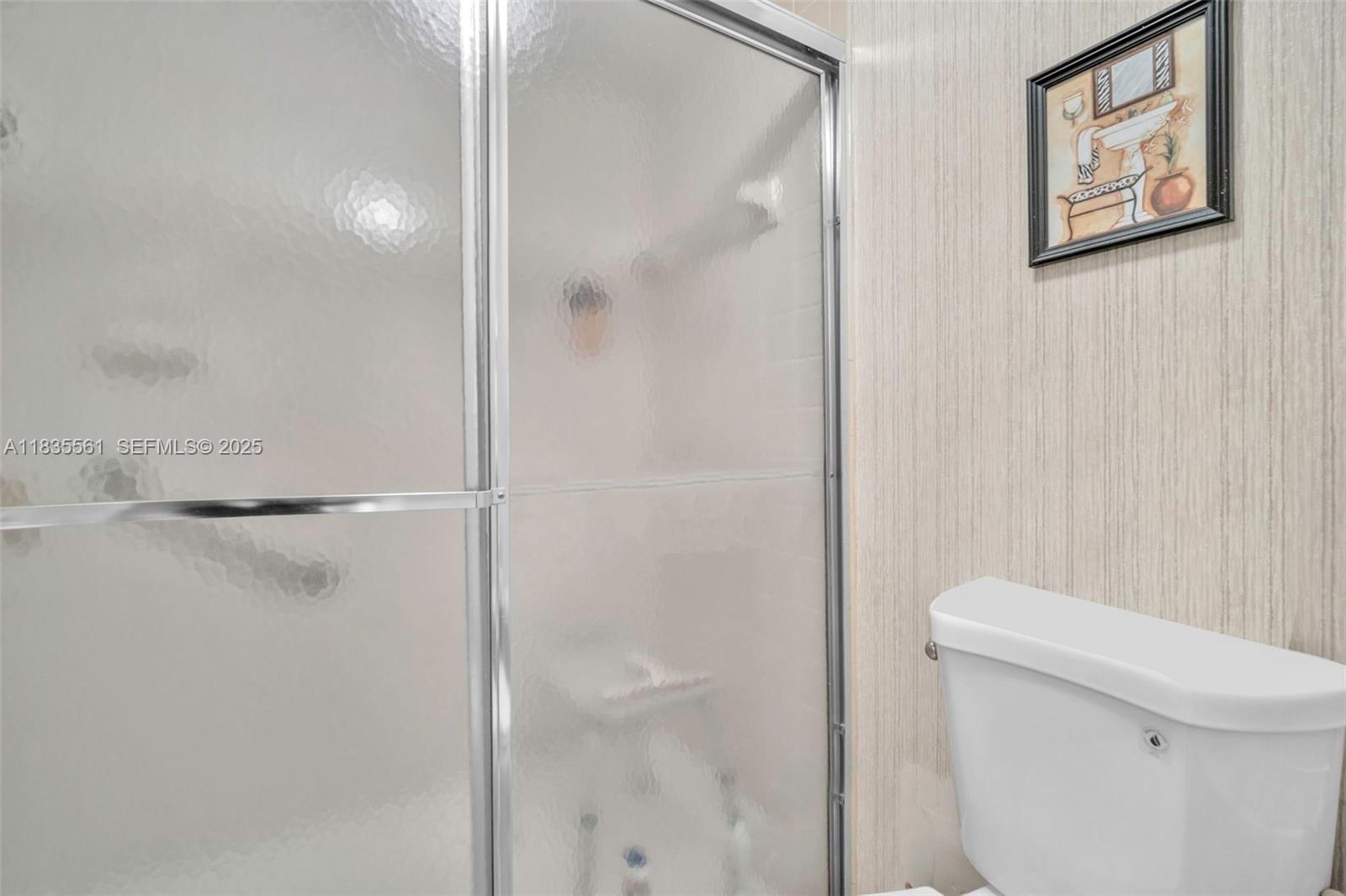 10400 Northwest 30th Court, Unit 305 Sunrise, FL 33322 - Photo 20 of 26 a bathroom with a shower and a toilet