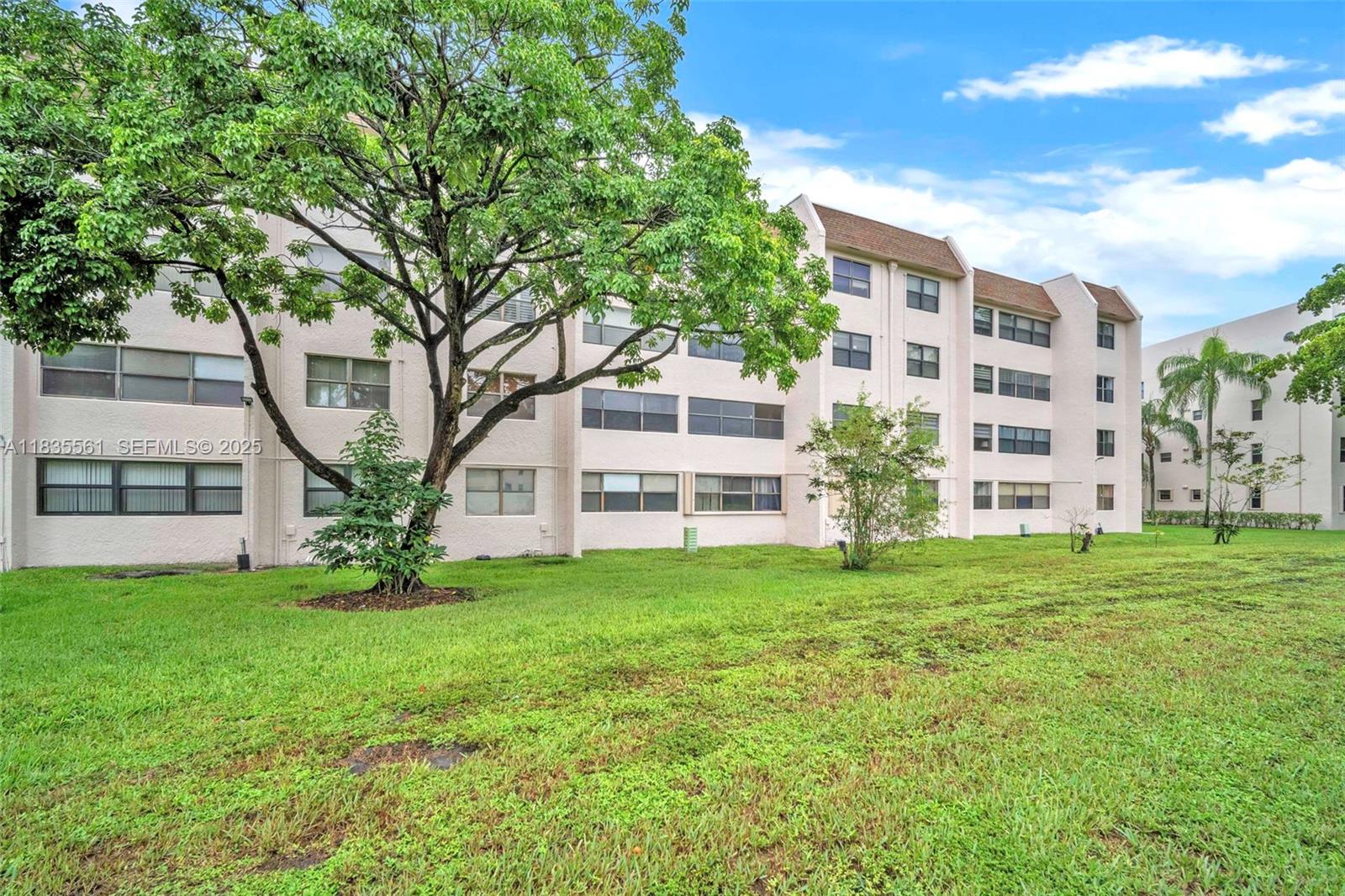 10400 Northwest 30th Court, Unit 305 Sunrise, FL 33322 - Photo 25 of 26 a house view with a garden space