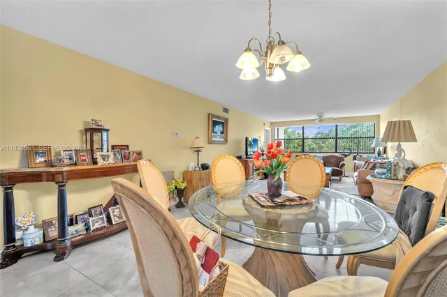 a dining room with furniture a rug and a chandelier