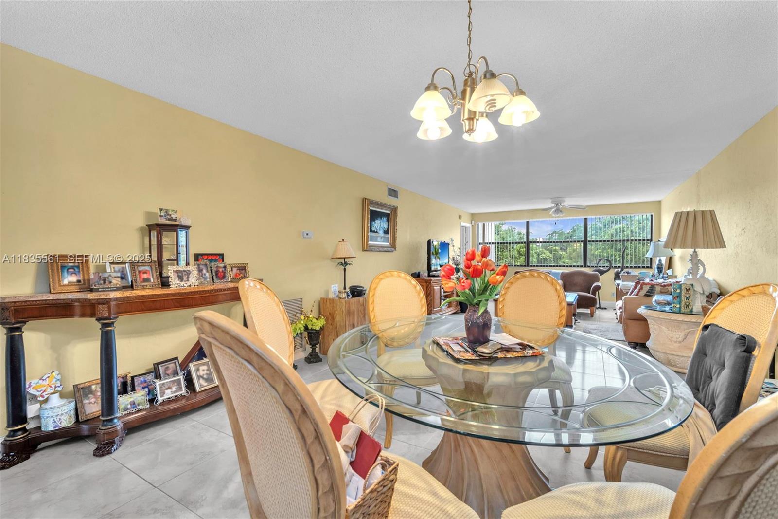 10400 Northwest 30th Court, Unit 305 Sunrise, FL 33322 - Photo 4 of 26 a dining room with furniture a rug and a chandelier