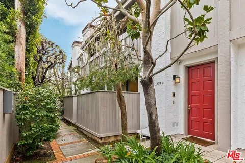 a couple of potted plants in front of door