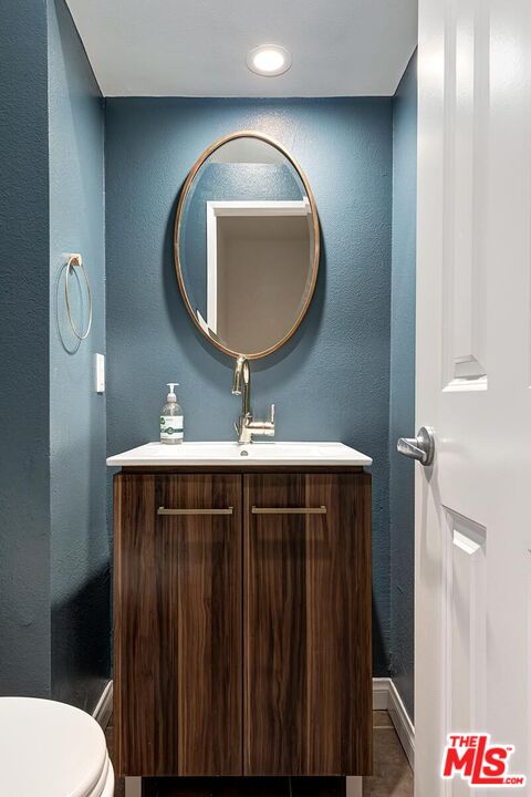 1013 21st Street, Unit B Santa Monica, CA 90403 - Photo 14 of 28 a bathroom with a toilet a sink and mirror