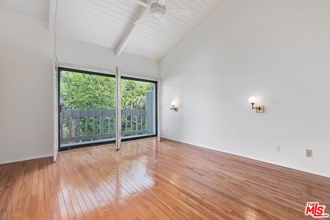 1013 21st Street, Unit B Santa Monica, CA 90403 - Photo 15 of 28 a view of an empty room with wooden floor and a window