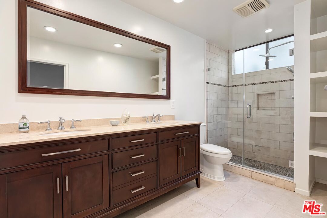 1013 21st Street, Unit B Santa Monica, CA 90403 - Photo 17 of 28 a bathroom with a double vanity sink mirror and toilet