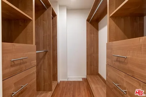 a view of a room with wooden floor and bench