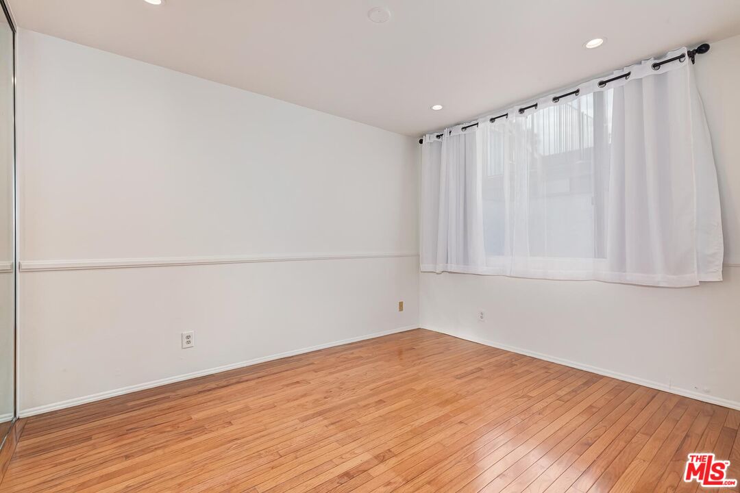 1013 21st Street, Unit B Santa Monica, CA 90403 - Photo 19 of 28 a view of a room with wooden floor and bench