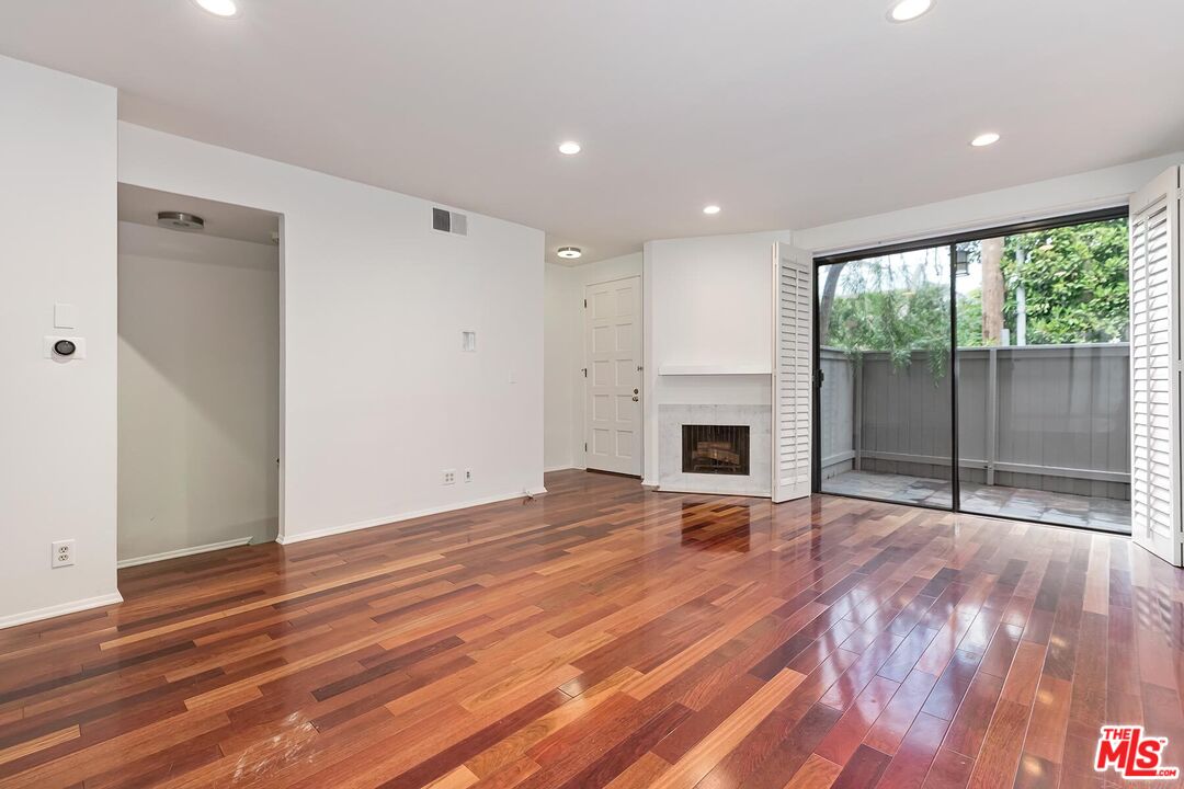 1013 21st Street, Unit B Santa Monica, CA 90403 - Photo 3 of 28 a view of empty room with wooden floor and fireplace