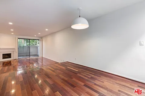 a kitchen with granite countertop white cabinets and stainless steel appliances