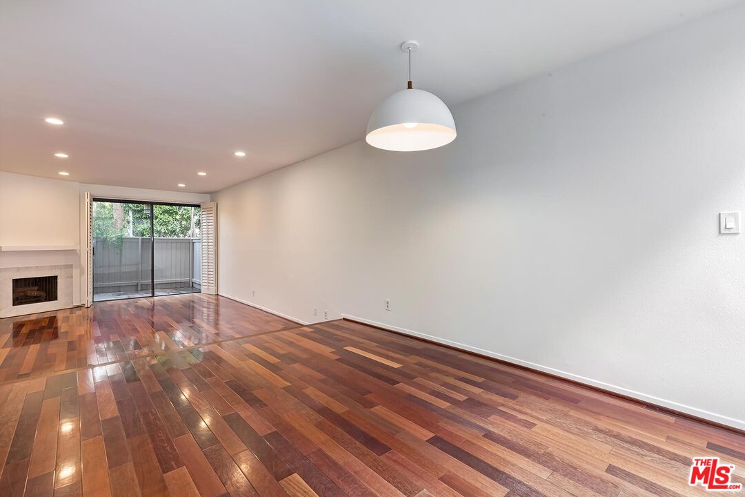1013 21st Street, Unit B Santa Monica, CA 90403 - Photo 10 of 28 a view of an empty room with wooden floor and a window