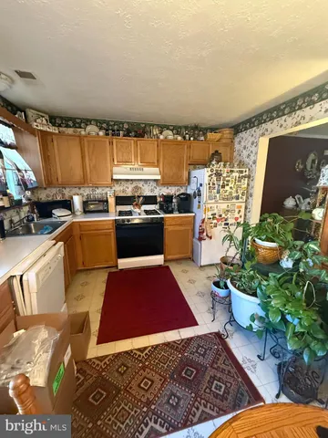 a living room with furniture fireplace and a table