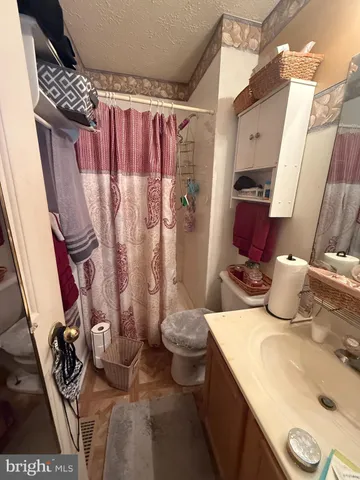 a bed room with a bed and a night stand