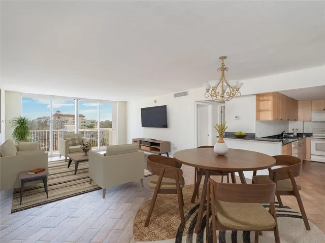 a living room with furniture a chandelier and a table