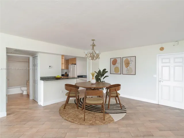 a living room with a patio furniture and a chandelier