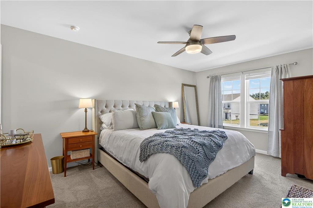 1274 Martin Road Breinigsville, PA 18031 - Photo 10 of 18 Multi-pane windows invite natural light across the comfortable carpeted flooring of this restful bedroom.