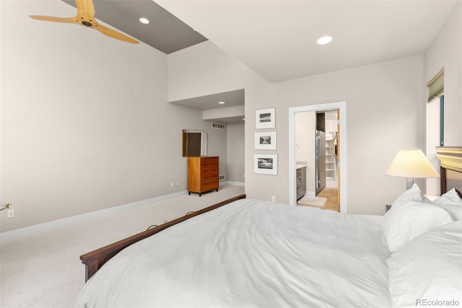 4515 West Moncrieff Place Denver, CO 80212 - Photo 13 of 29 a bedroom with a bed and a chandelier